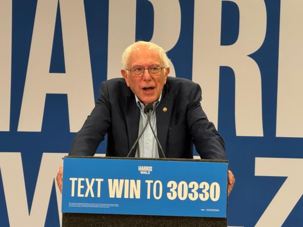 Sen. Bernie Sanders at a podium, addressing Las Vegas supporters of the Harris-Walz ticket