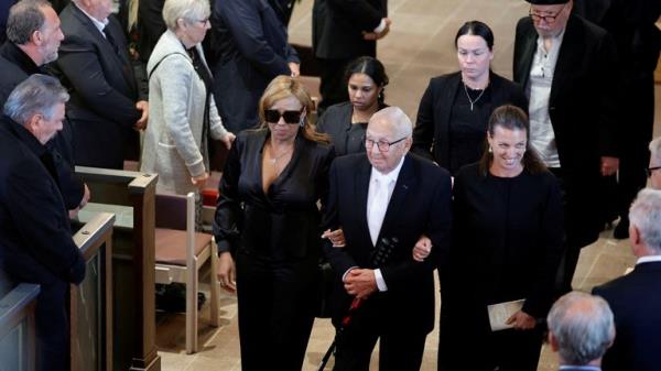 The procession walks through the town of Torsby after the funeral. Pic: PA